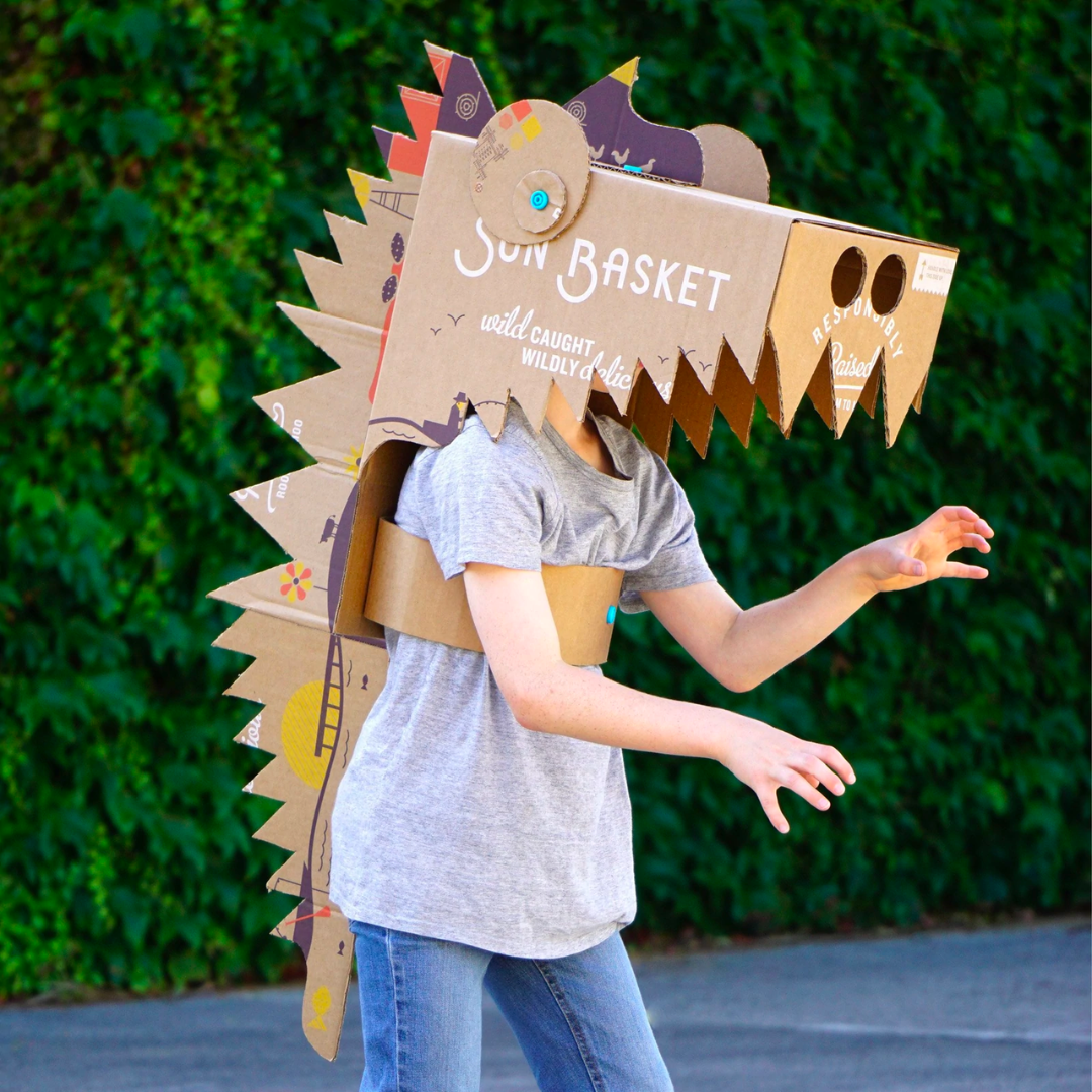 Teen kid wearing handmade cardboard crocodile mask costume