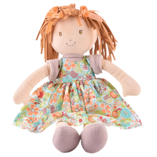 A 35cm rag doll with toffee brown hair, wearing a floral dress and two ribbons in her hair.