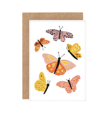 A colorful greeting card with illustrated butterflies on it, accompanied by a brown Kraft envelope.