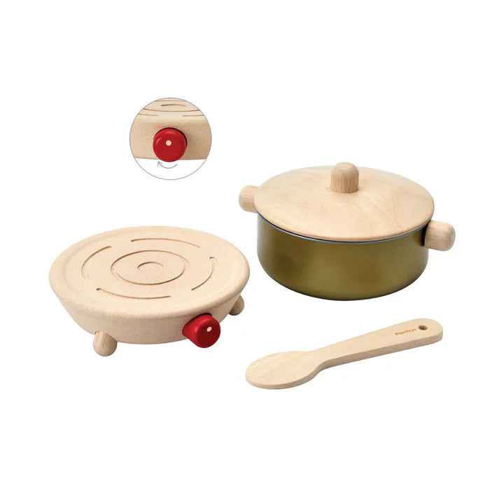 Wooden toy cookware set with pot, pan, and spoon on a white background