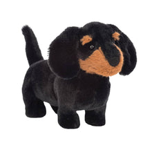 A small plush toy resembling a dachshund with black fur and brown ears, designed for children.