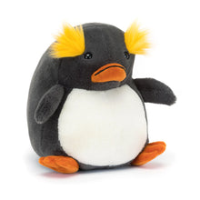 A plush toy depicting a blue-grey penguin with a round cream bib and custard-yellow tufts, featuring waggly flippers and a down turned piped orange bill.