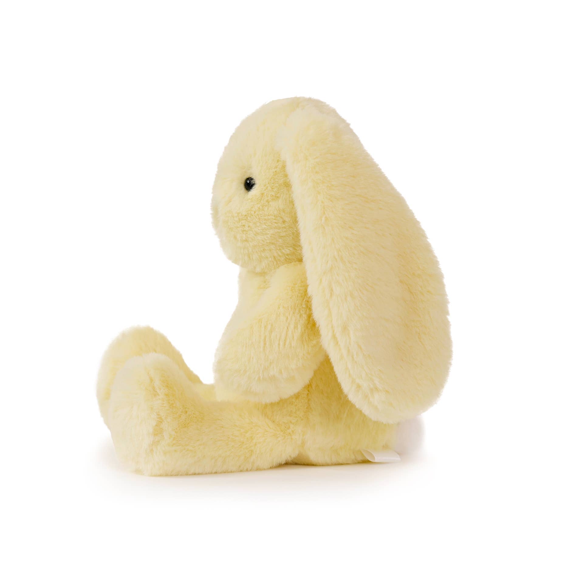 Plush toy resembling a yellow bunny on a white background