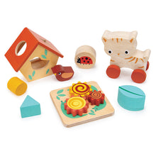 Set of wooden toys including a cat, bird, ladybug, and various shapes on a white background