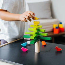 Child playing with colorful wooden blocks on a table