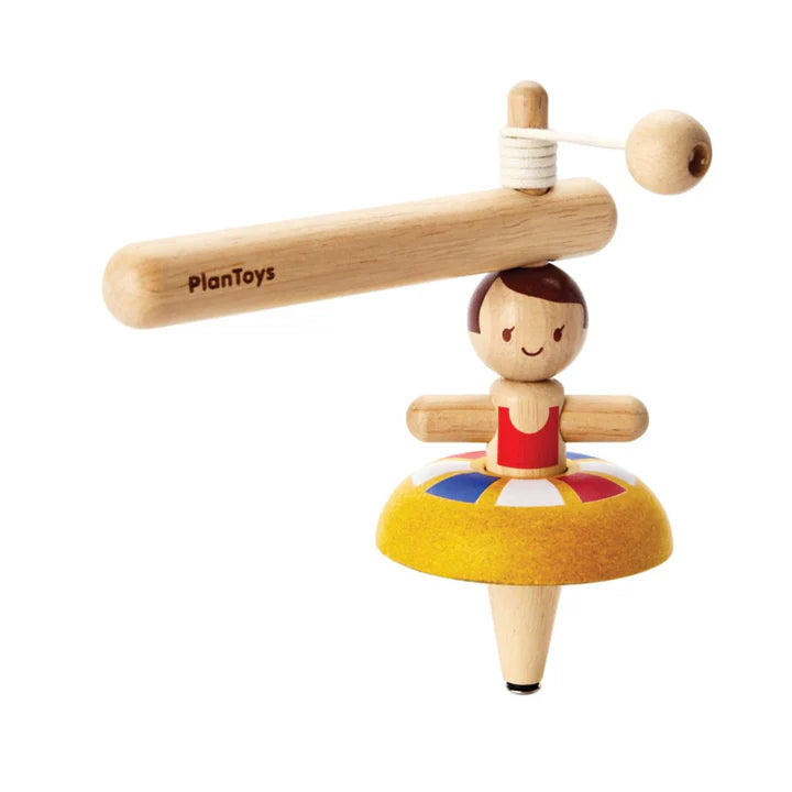 Wooden toy with a character on a colorful platform, branded 'PlanToys', on a white background