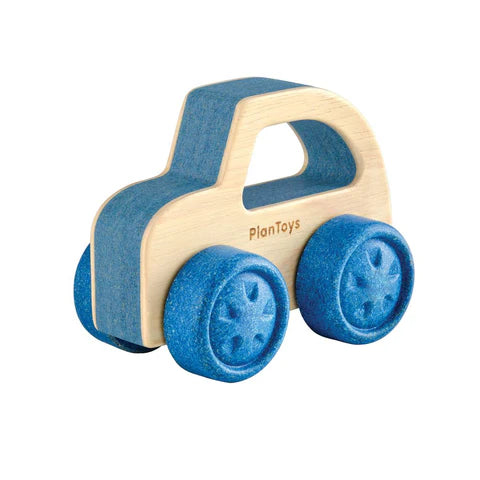 A wooden toy car with blue wheels and natural wood body, labeled PlanToys.