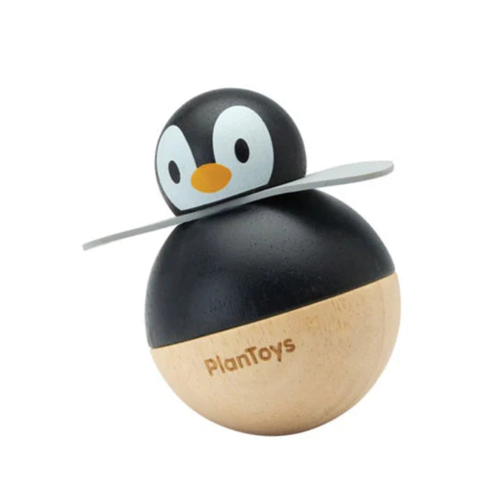 Wooden penguin toy with black and beige body on a white background