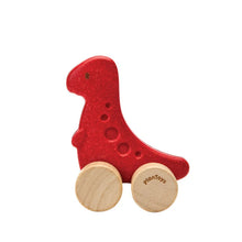 Red wooden dino rex car toy with wheels on a white background