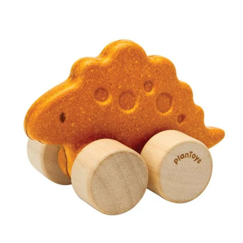Wooden toy dinosaur with wheels on a white background