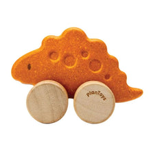 Wooden toy dinosaur with wheels on a white background