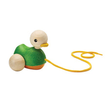 Wooden toy duck with a yellow string on a white background