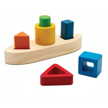 Wooden shape sorting toy with colorful blocks on a white background