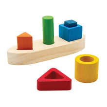 Colorful wooden shape sorting toy on a white background