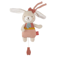 A plush toy resembling a musical hare with a pink bow, blue overalls, and a beige body, with a pull-string mechanism at the bottom.