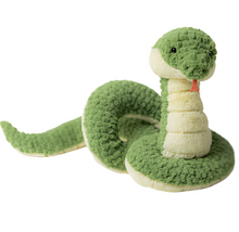 A plush toy resembling a snake with forest green and pale-yellow fur, soft textured scales, and a smiling face.
