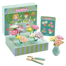 Children's floral bouquet playset with various colorful flowers, holders, a wooden vase, pruning shears, and packaging that doubles as a display tray.