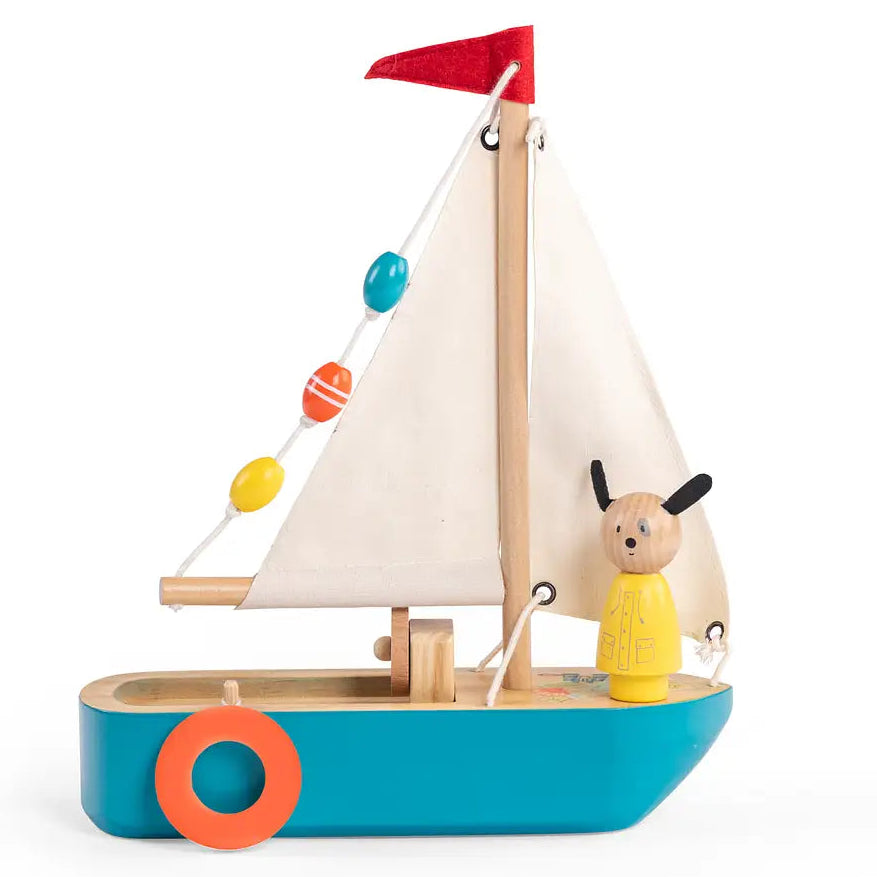 Toy sailboat with a dog figure on a white background