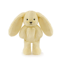 Yellow plush bunny toy on a white background