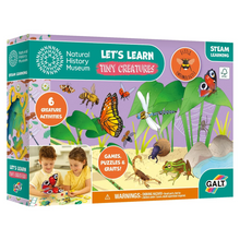 Boxed educational toy set 'Let's Learn Tiny Creatures' featuring images of children engaging with the activity kit, which includes illustrations of insects and spiders. The toy box is colorful with green, purple, and orange tones, and it displays the Galt brand logo.