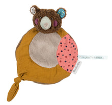 A brown bear comforter with a soft texture, accented with fur, featuring a small knot for holding and gnawing.