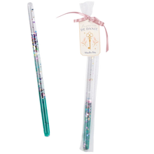 A green magic wand made of plastic/acrylic tube with a clear gel and green glitter, presented in a tulle bag with a satin ribbon.