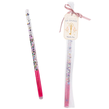 A pink magic wand with glitter and sequins, presented in a tulle bag tied with a satin ribbon.
