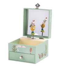 A musical jewellery box with a rabbit and foliage design, open, showing the interior with a wind-up mechanism and a small drawer.