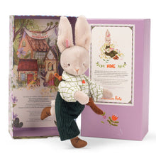 A soft toy rabbit doll in a shirt and pants, with a bow tie, standing in front of an illustrated gift box.