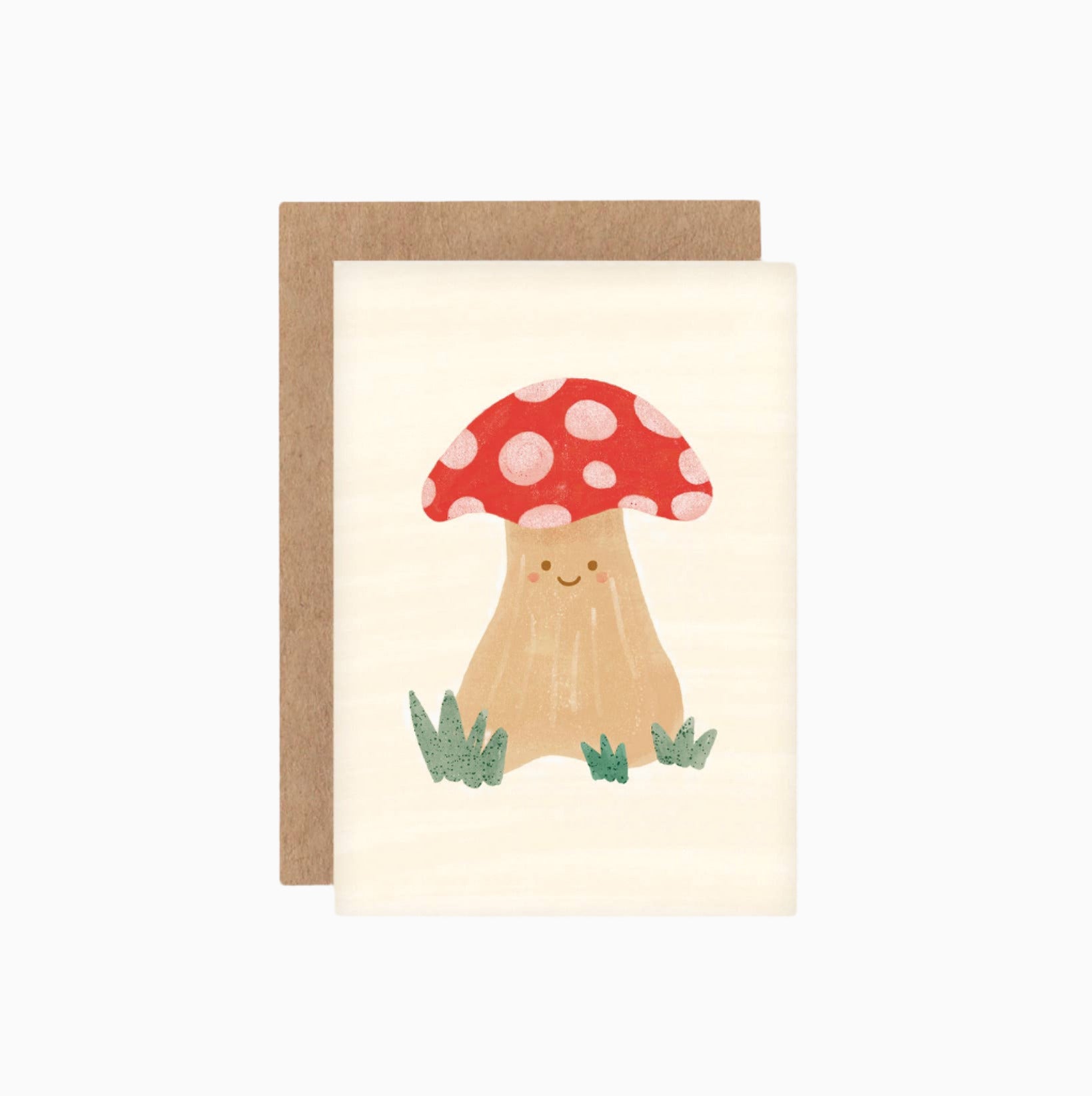 A cute illustrated greeting card featuring a smiling mushroom with a red cap, attached to a brown Kraft envelope, against a white background.