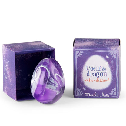 Purple and white egg shaped rubber bouncing  ball with packaging on a white background