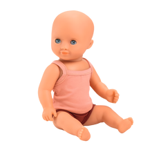 A 32 cm hard-body doll with blue eyes, dressed in a pink singlet top and underpants, designed for children from 18 months old and up.