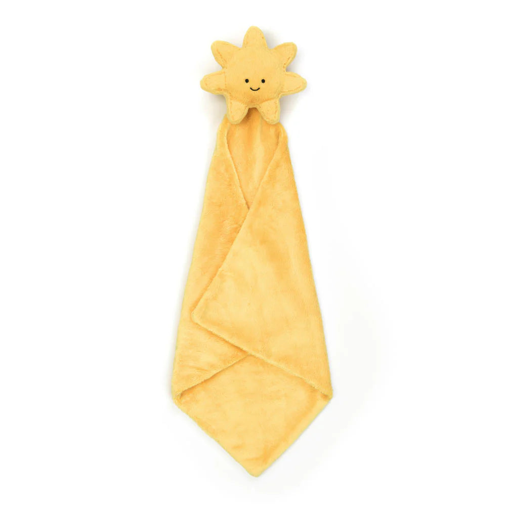 A plush toy in the shape of a sun with a smiling face, wrapped in a soft, yellow blanket with a Baby Jellycat grosgrain ribbon.