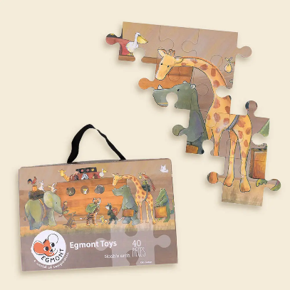 Wooden puzzle with animals and packaging on a beige background