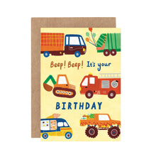 A colorful greeting card with illustrations of a truck, rubbish truck, fire engine, digger, ice cream van, and monster truck. The text on the card reads 'Beep! Beep! It's your BIRTHDAY'.
