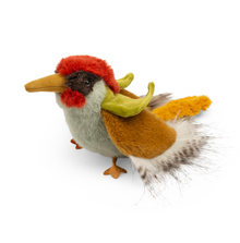 A plush toy resembling a colorful woodpecker with a red and yellow beak, green body, and a fluffy tail.
