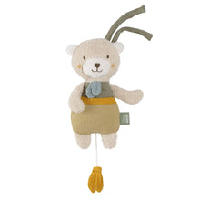 A plush toy resembling a bear with a musical mechanism, primarily in beige and brown colors, with a blue bow tie and yellow feet.
