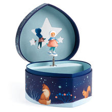 A heart-shaped music box with a carved ice skater, open to show the interior compartment for storing jewelry or small musical instruments.