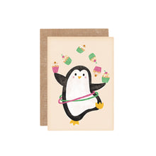 Illustrated mini greeting card with a cartoon penguin hula-hooping with cupcakes on a beige background. Comes with a brown envelope.