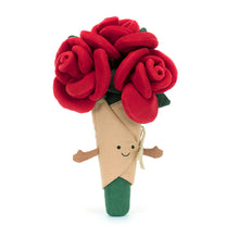 A plush toy resembling a bouquet of red roses with green leaves, wrapped in beige linen with a smiling face embroidered on it.