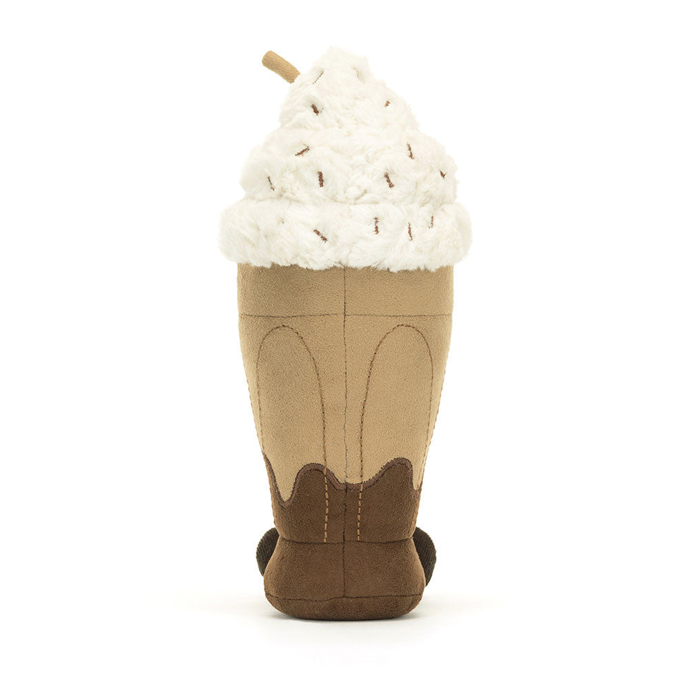 A soft toy representing a chocolate sundae drink with whipped cream, sprinkles and a brown straw.