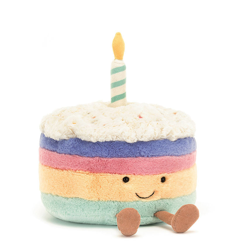 Plush toy cake with a candle on a white background