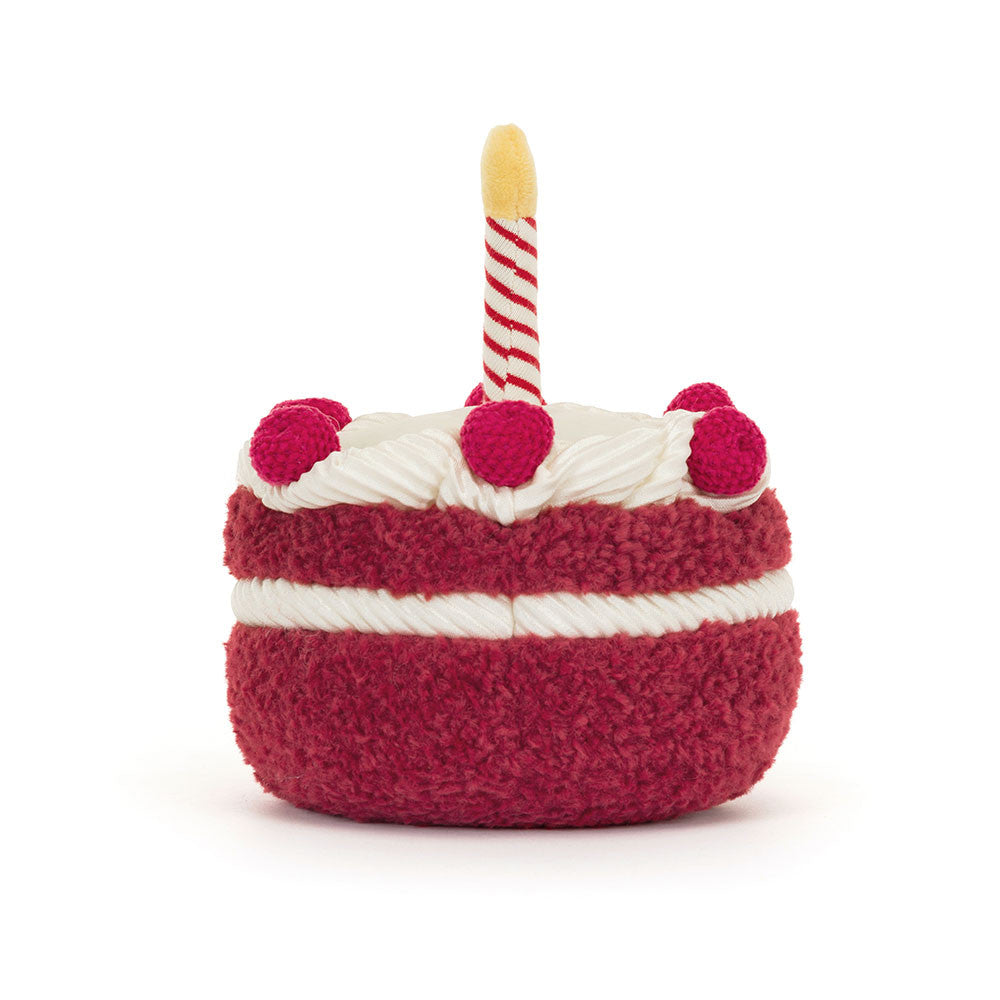 Jellycat cake-shaped toy with a candle on a white background