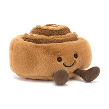 Plush cinnamon roll toy with a smiling face on a white background
