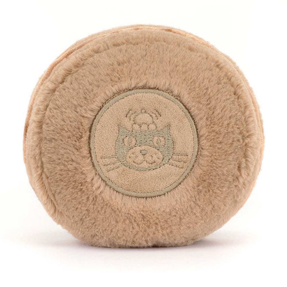 Beige plush ball with a Jellycat logo on a white background