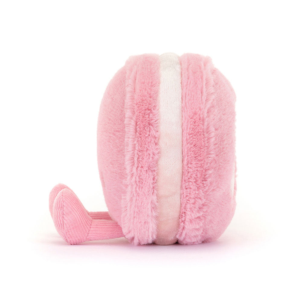 Pink plush toy resembling a macaron on a white background