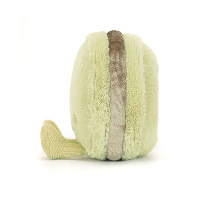 Light green and brown toy resembling a macaron on a white background