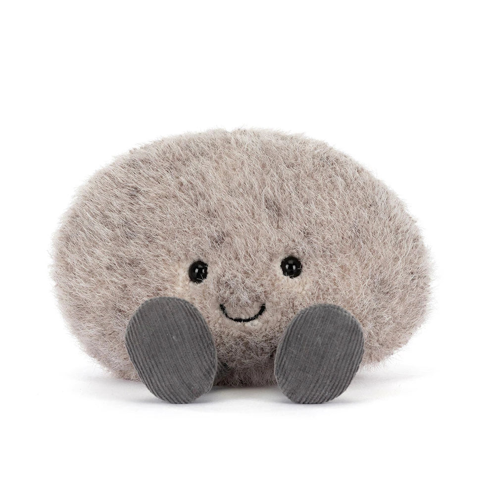 Plush toy resembling a round grey pebble with a smiling face on a white background