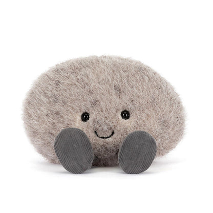 Plush toy resembling a round grey pebble with a smiling face on a white background