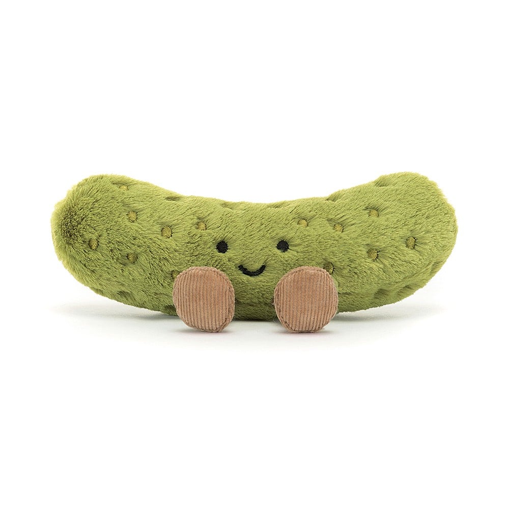 A plush toy in the shape of a pickle with a smiling face, embroidered freckles, and nutty cord boots.